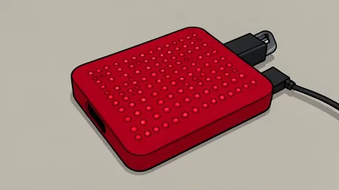 A flexible red light therapy belt wrapped around a person's lower back and a silicone facial mask resting on a table