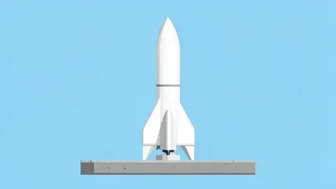 A white rocket standing vertically on a concrete launch pad