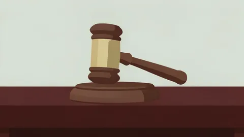 A wooden gavel resting on a dark mahogany desk