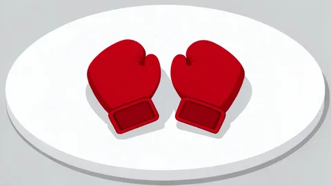 A pair of red boxing gloves resting on a canvas ring floor