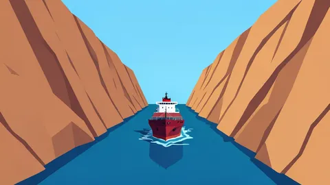 A narrow sea strait flanked by steep, arid cliffs with a cargo ship passing through the water