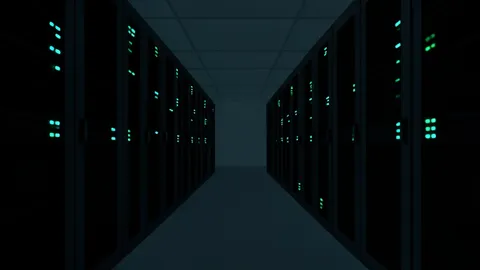Rows of black server racks with blinking status lights in a dimly lit data center aisle