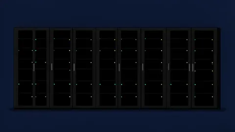 A row of black server racks with blinking status lights in a dark data center room