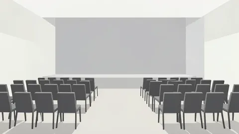A modern conference hall with rows of empty chairs facing a stage