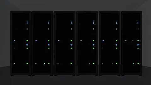 A row of black server racks with blinking status lights in a dimly lit data center