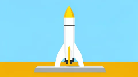 A white rocket standing vertically on a concrete launch pad