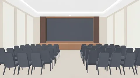 A large hotel conference room with rows of chairs and a stage