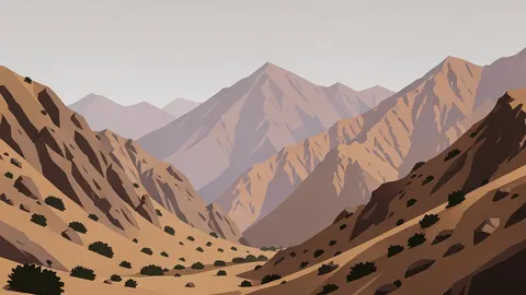 A rugged, arid mountain range with steep rocky slopes and sparse vegetation under a hazy sky