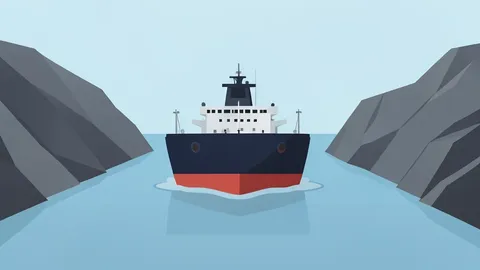 A massive oil tanker ship moving through a narrow strait