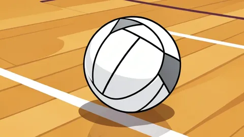 A white volleyball resting on a polished indoor court floor