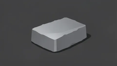 A raw, metallic ingot of rare earth material resting on a dark industrial surface