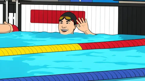 A large indoor swimming pool with blue water and lane ropes