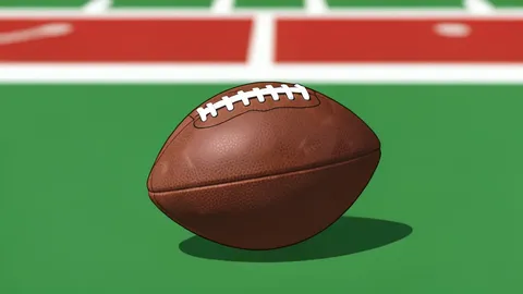A green artificial turf field with white yard lines and a football resting on a tee