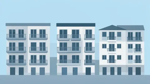 A row of multi-story apartment buildings with balconies under a clear sky
