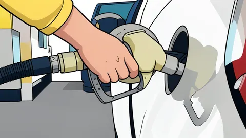 A fuel pump nozzle resting on a concrete island at a gas station.