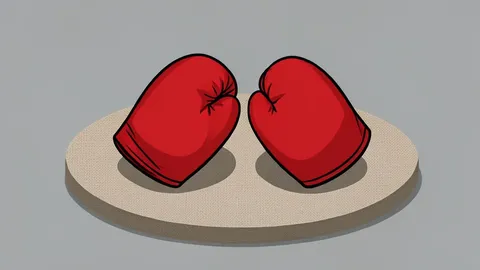 A pair of red leather boxing gloves resting on a canvas ring floor