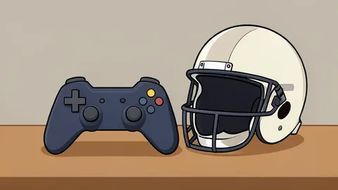 A video game controller resting on a desk next to a football helmet