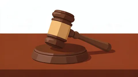 A wooden gavel resting on a polished mahogany desk surface