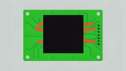 A close-up of a green printed circuit board featuring a large black heat sink and copper heat pipes.