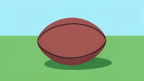 A rugby ball resting on green grass