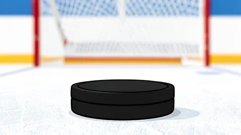A pair of ice hockey skates resting on a sheet of white ice