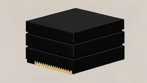 A stack of black rectangular computer memory modules with gold contact pins