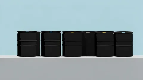 A row of black oil barrels sitting on a concrete dock