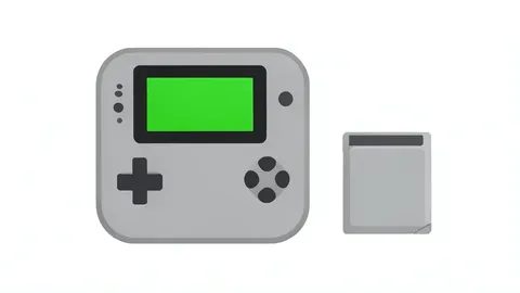A grey handheld gaming console with a small green screen and directional pad sits next to a small grey cartridge with a label.