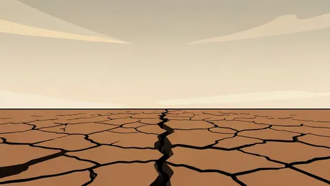 A cracked, dry riverbed stretching into the distance under a hazy, heat-distorted sky.