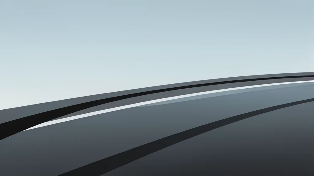 A wet asphalt racetrack surface with dark tire marks and reflections of grey sky