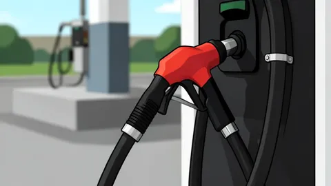 A single fuel nozzle resting on a concrete gas station island.