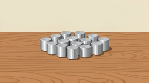 A cluster of small, cylindrical metallic magnets arranged on a workbench