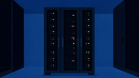 A server rack with blinking status lights in a dimly lit data center