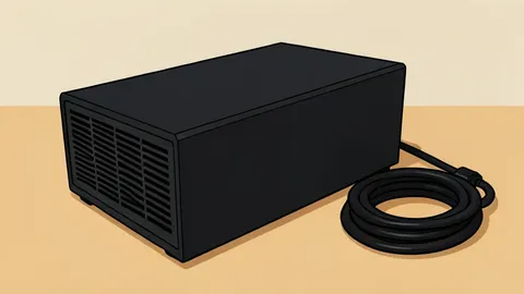 A small, black rectangular computer chassis sitting on a wooden desk