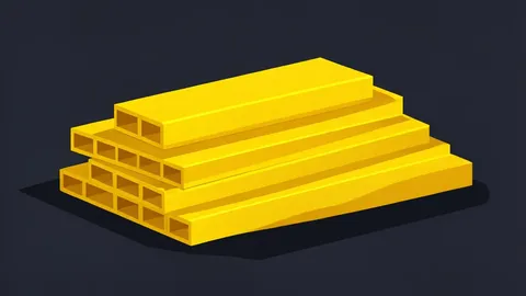A pile of shiny, yellow metal bars stacked on a dark surface