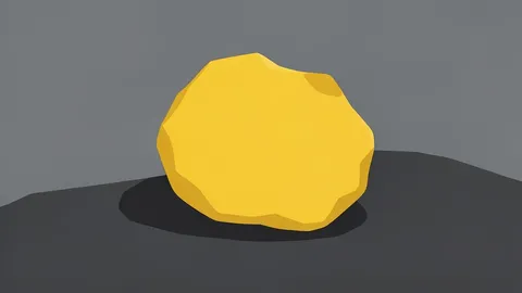 A rough, unrefined nugget of yellow metal resting on a dark stone surface