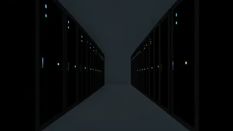Rows of black server racks with blinking status lights in a dimly lit data center aisle