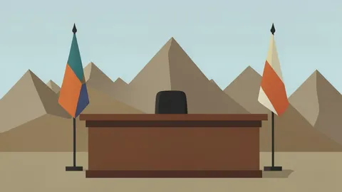 A diplomatic meeting table with two national flags standing on either side, set against a backdrop of a mountainous border landscape.