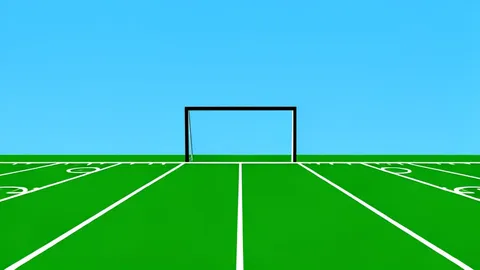 A green football field with white yard lines and goalposts in the distance
