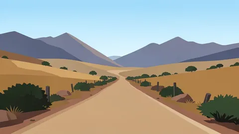 A dusty rural road winding through the highlands of Ethiopia with distant mountainous terrain under a clear sky.