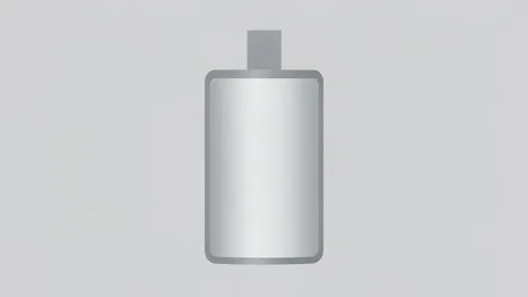 A close-up of a cylindrical lithium-ion battery cell with a metallic casing and a positive terminal tab