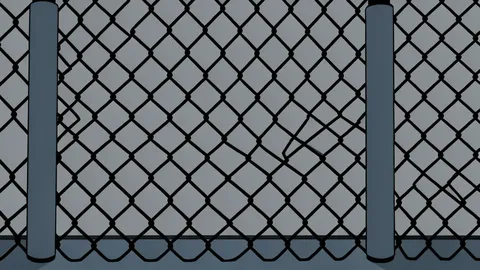 A padded octagonal fighting cage with white ropes and a central canvas floor.