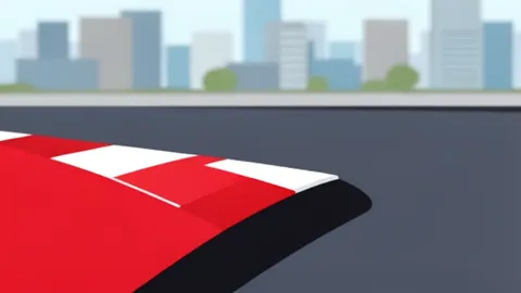 A temporary street circuit with red and white curbs running through a city street lined with buildings