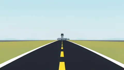 A paved airport runway stretching into a hazy horizon with a control tower in the distance