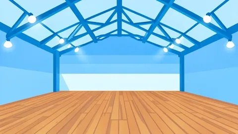 A wide-angle view of a large indoor sports arena with a polished wooden floor and high ceilings, emphasizing the scale and emptiness of the space.