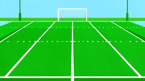 A green football field with white yard lines and goalposts in the distance