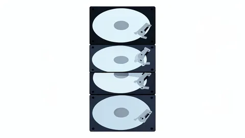 A stack of hard disk drives with visible platters and actuator arms