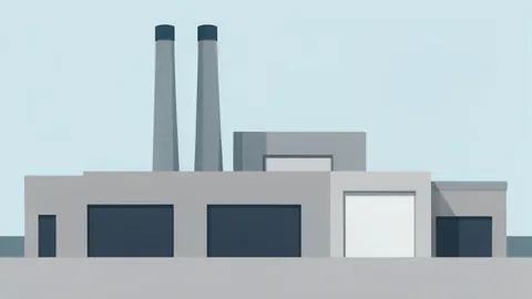 A modern industrial factory exterior with large ventilation stacks and loading docks