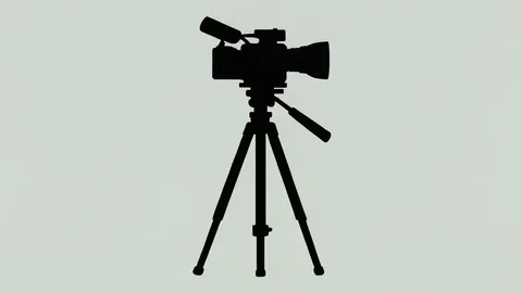 A video camera on a tripod in a studio setting