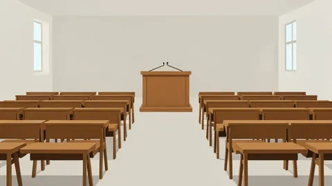 A university lecture hall with rows of empty wooden desks and a podium
